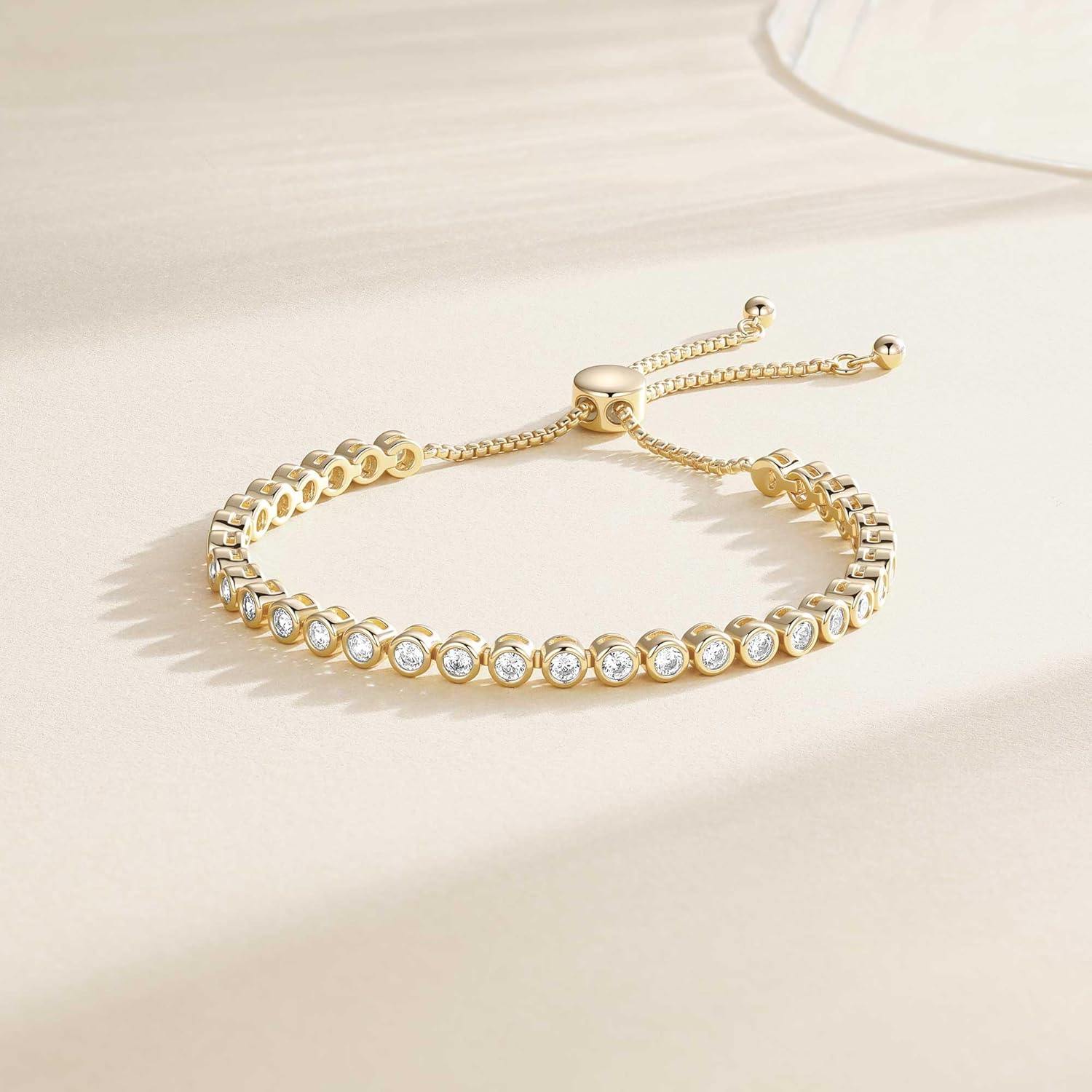 Adjustable sterling silver tennis bracelet with cubic zirconia stones and 14K gold plating, classic fine jewelry style