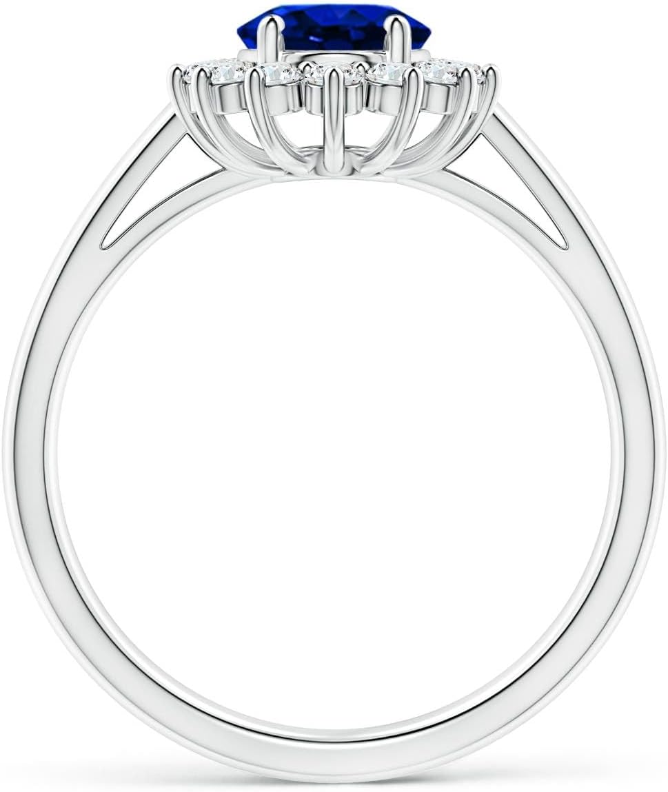Blue sapphire halo ring in 14K gold and platinum with romantic princess Diana inspired design