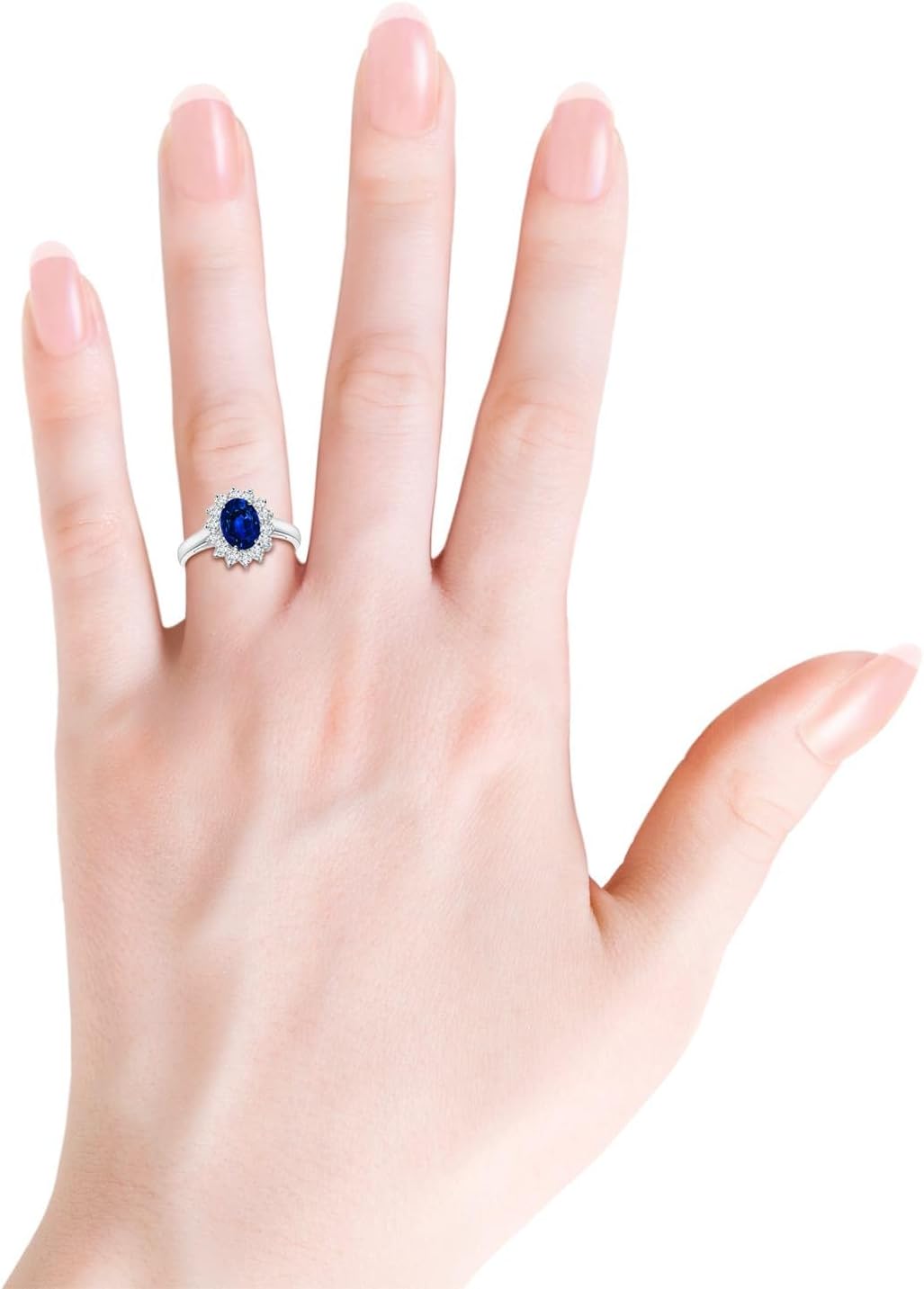 Blue sapphire halo ring in 14K gold and platinum with romantic princess Diana inspired design
