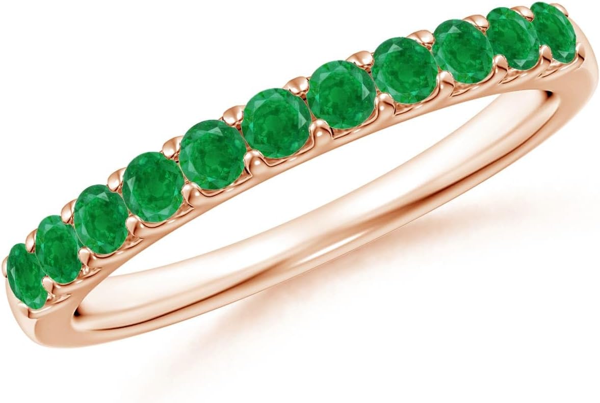Emerald half eternity wedding band in 14K gold with shared prong setting, romantic gemstone design