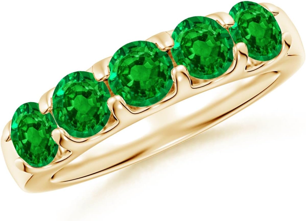 Emerald half eternity wedding band in 14K gold with shared prong setting, romantic gemstone design