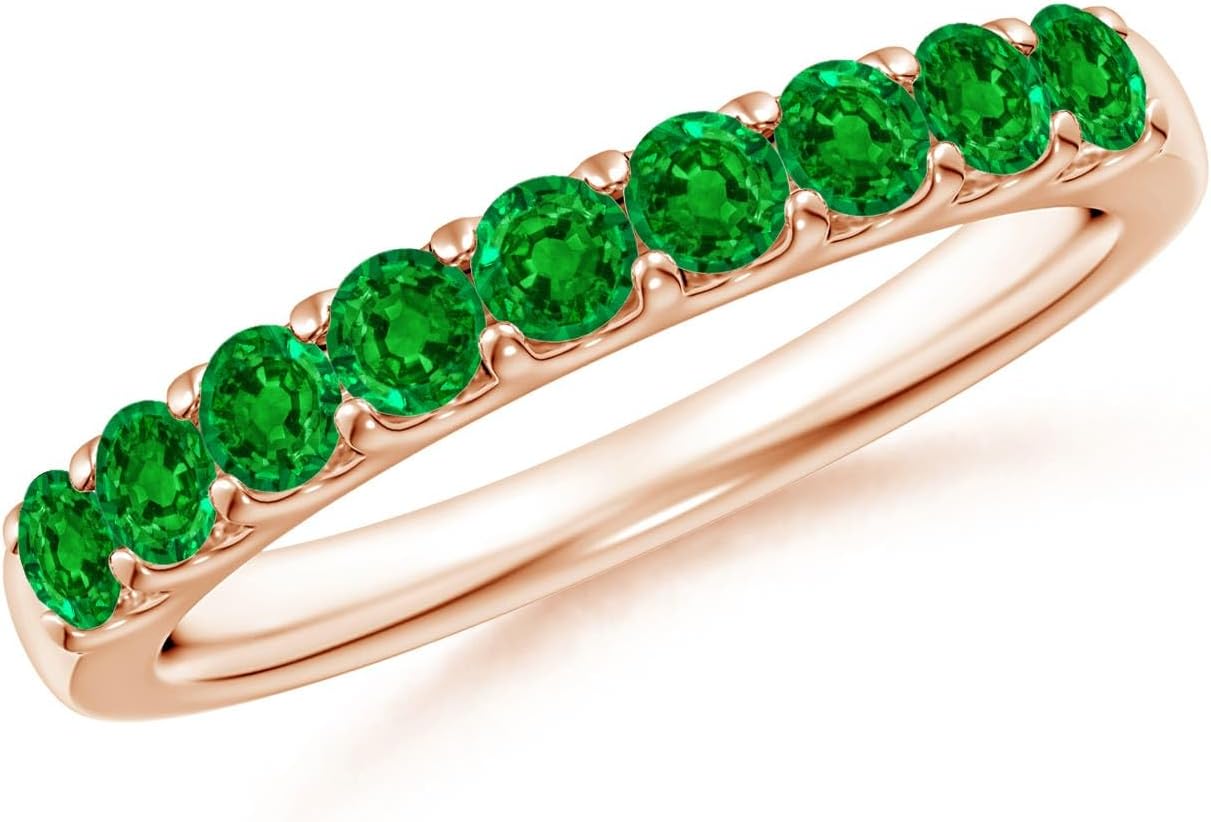 Emerald half eternity wedding band in 14K gold with shared prong setting, romantic gemstone design
