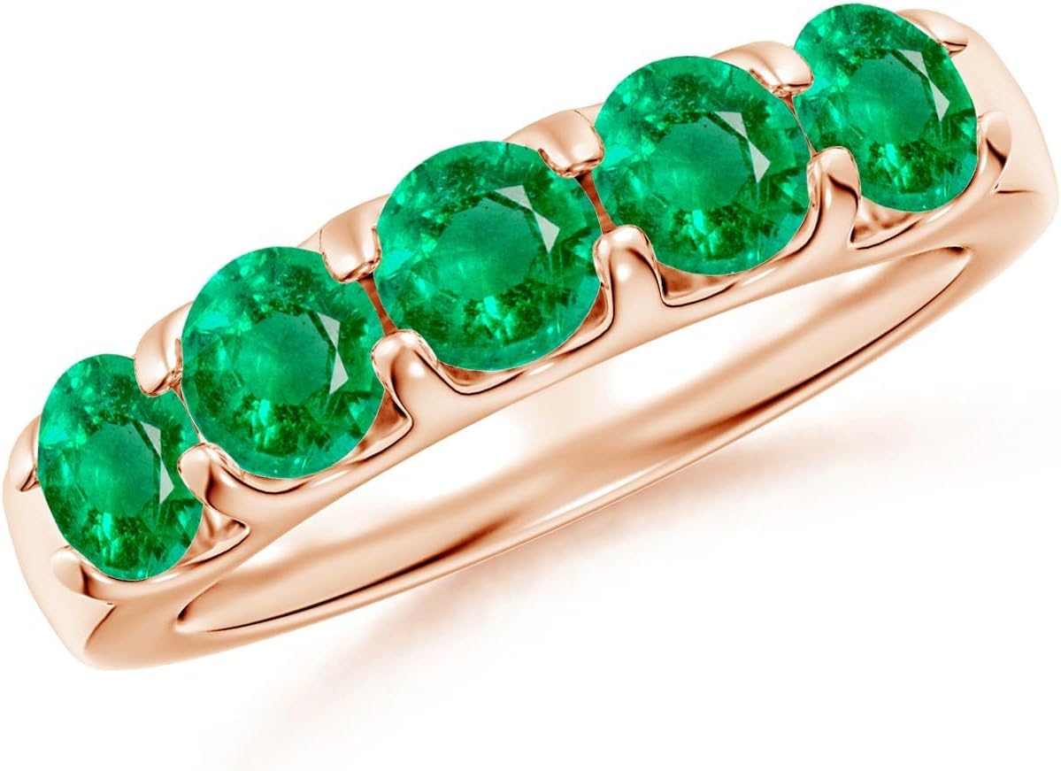 Emerald half eternity wedding band in 14K gold with shared prong setting, romantic gemstone design