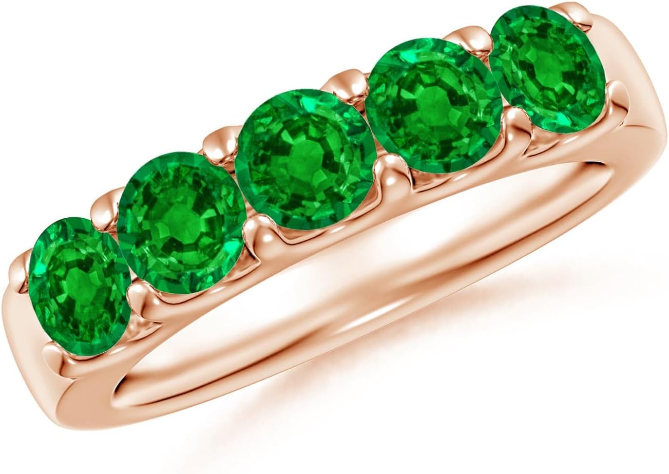 Emerald half eternity wedding band in 14K gold with shared prong setting, romantic gemstone design