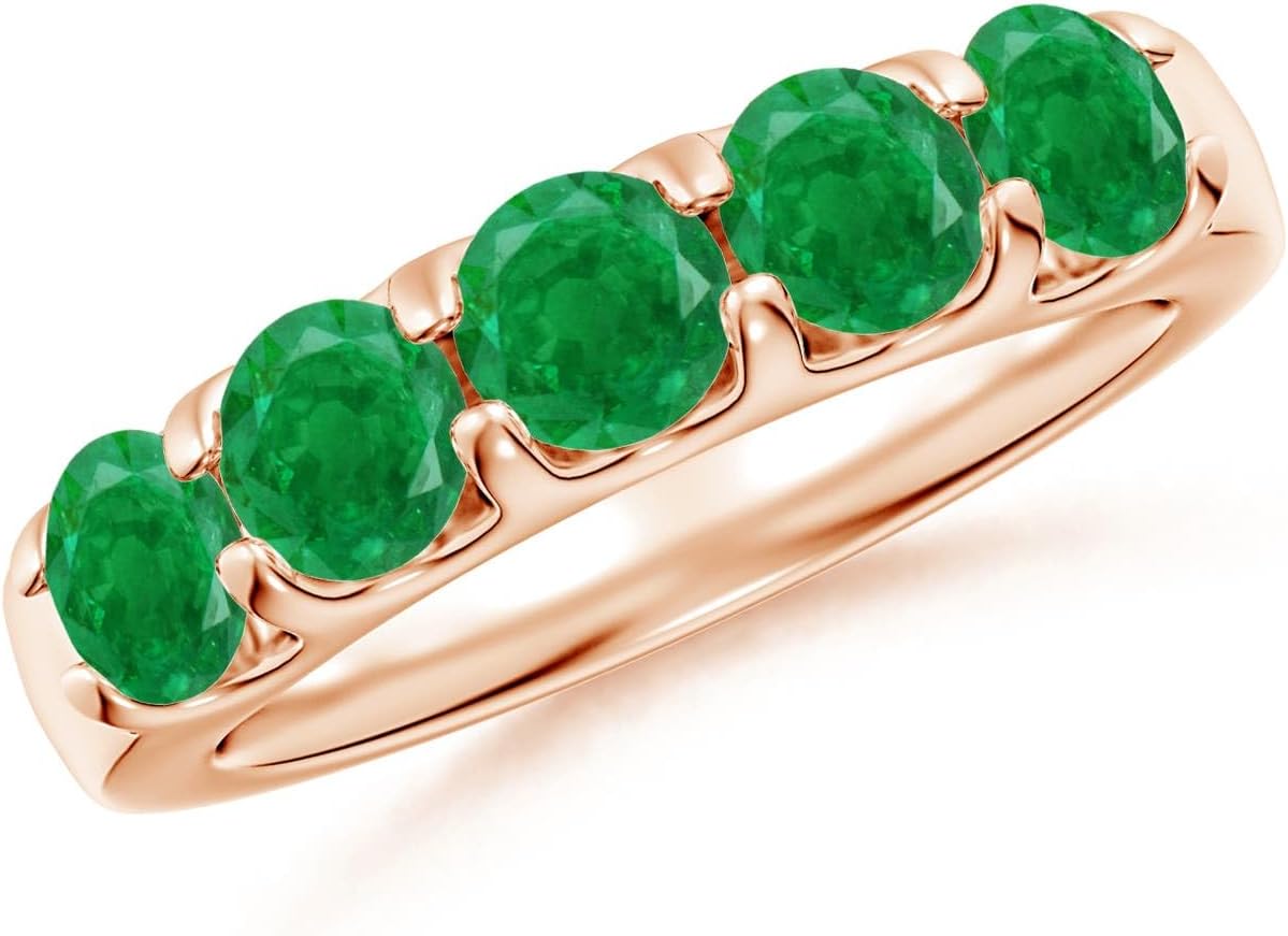 Emerald half eternity wedding band in 14K gold with shared prong setting, romantic gemstone design