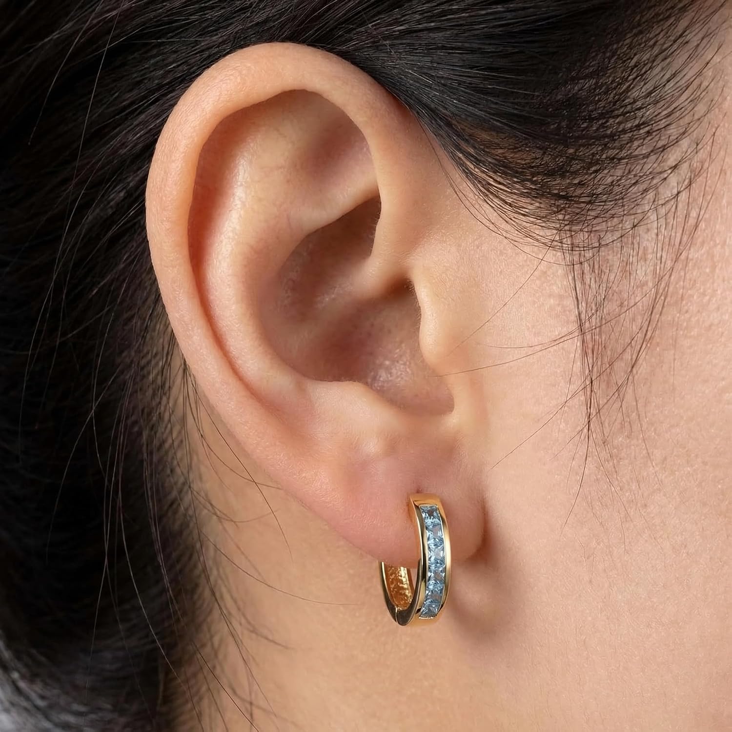 14K yellow gold aquamarine huggie hoop earrings with March birthstone gemstones, classic fine jewelry style